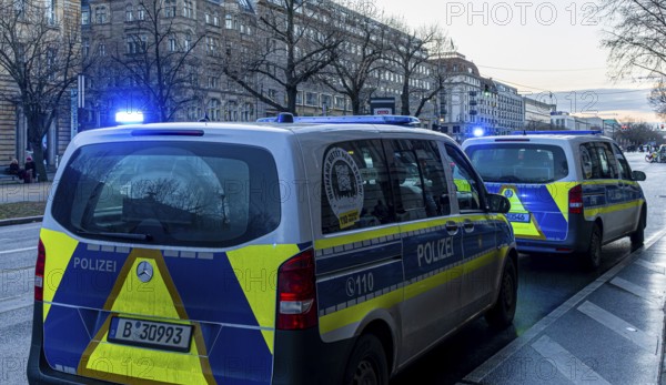 Police vehicles with flashing lights switched on, special operation at the Berlin State Library,