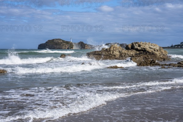 Castlepoint Beach and Castlepoint Lighthouse, ocean, waves, surf, sandy beach, rocks. Castlepoint,
