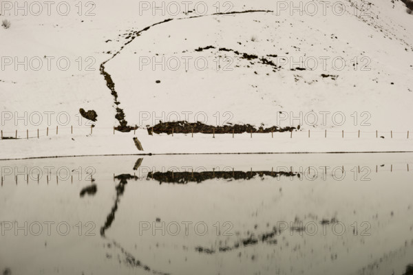 Another onset of winter in May, Riezler Alpsee, an artificially created lake, snow pond, feeds the