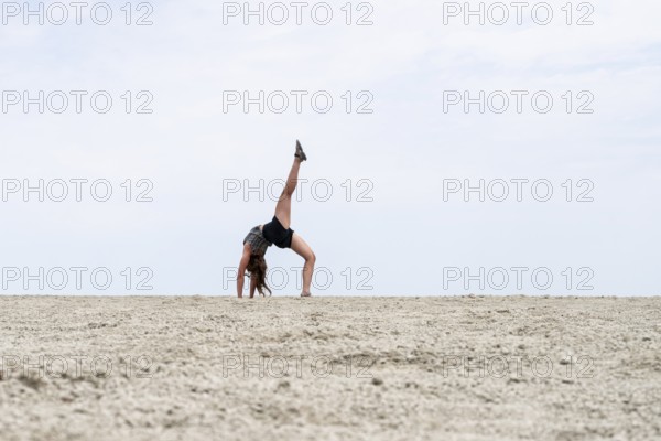 Abstract, woman doing gymnastics in a whirring landscape, Etosha pan, Etosha National Park, Namibia