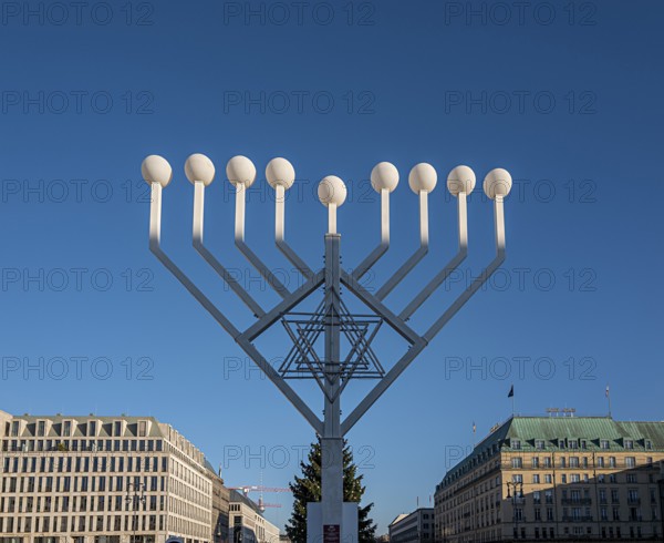 Large Hanukkah chandelier at the Brandenburg Gate in daylight, sign of lively Jewish life, symbolic
