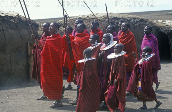 Maasai men and girls in their village in the Ngorongoro Crater dancing for tourists, Tanzania,