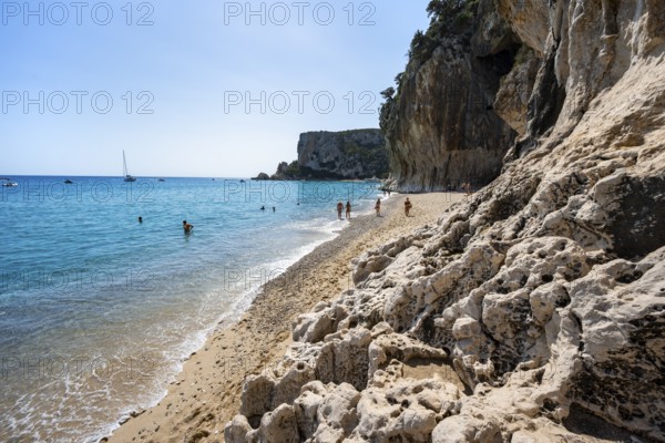 Sandy beach beach and steep cliffs at Cala Luna, Golfo di Orosei, Baunei, Sardinia, Italy