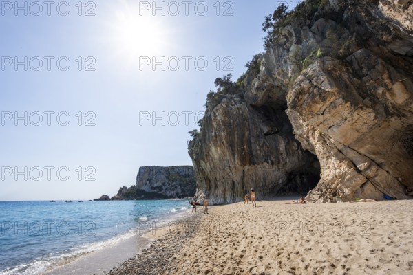 Sandy beach beach and steep cliffs with caves at Cala Luna, Golfo di Orosei, Baunei, Sardinia,