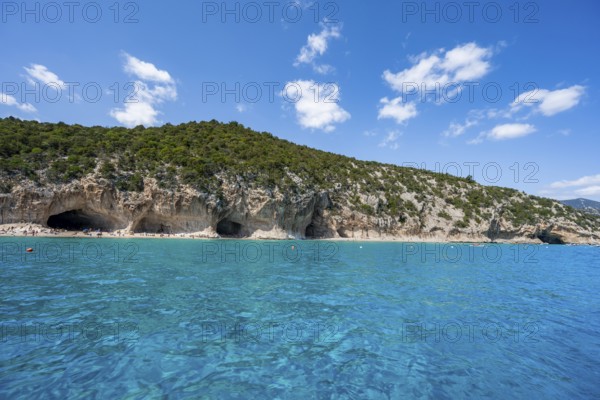 Clear blue water and picturesque rocky coast, Cala Luna cliffs and beach, Golfo di Orosei, Baunei,