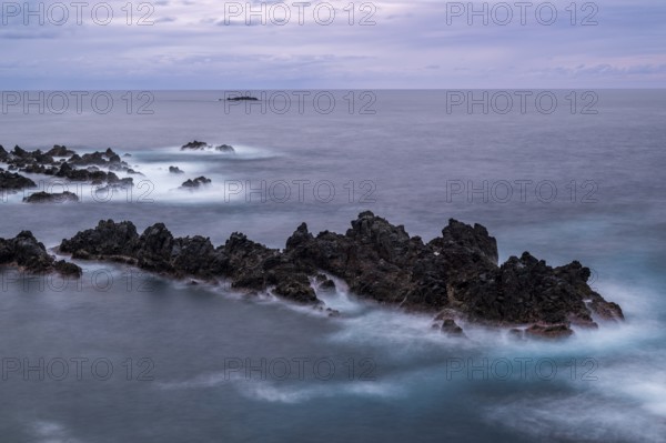 Sunset, long exposure, waves and rocks, coast near Porto Moniz, Madeira, Portugal