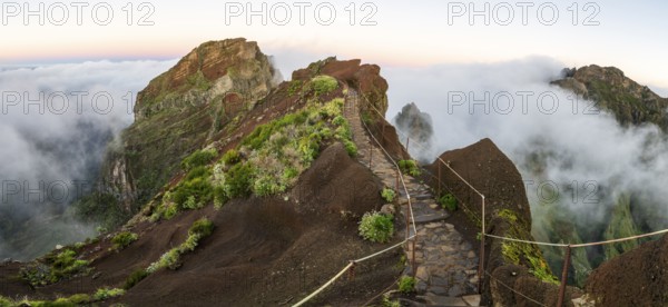 Sunrise at Pico do Arieiro, clouds of fog sweep over mountain peaks, sea of fog, hiking trail PR1,