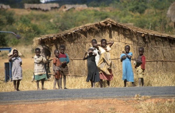 Children in front of a straw hut on the side of the road, Bwangu Mzimba, Malawi, Africa, June 2000,