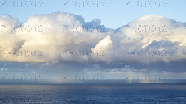 Rainbow over sea, dark rain cloud, rain, Madeira, Portugal