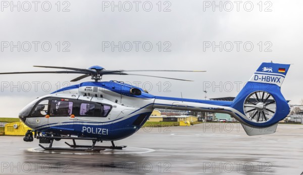 Helicopter from the Baden-Württemberg Police team in front of the hangar at the airport. Airbus