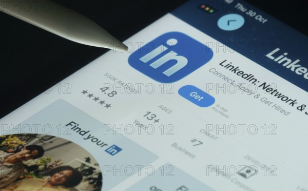 Dhaka, Bangladesh- 30 Oct 2025: LinkedIn app on a iPad screen with a pen pointing at the install