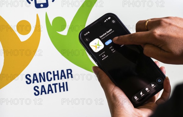 In this photo illustration, a person downloads the Sanchar Saathi mobile application on an iPhone,