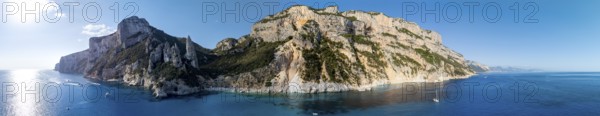 Panorama, picturesque rocky coast, cliffs with L'Aguglia pinnacle, blue sea and Cala Goloritzé
