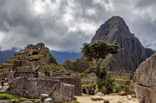 Dramatic sky over ancient ruins in front of a big mountain, The ruins of the Inca city of Machu
