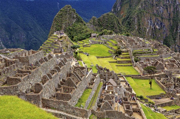 Extensive ruins and terraces in an ancient city nestled in mountains, the ruins of the Inca city of