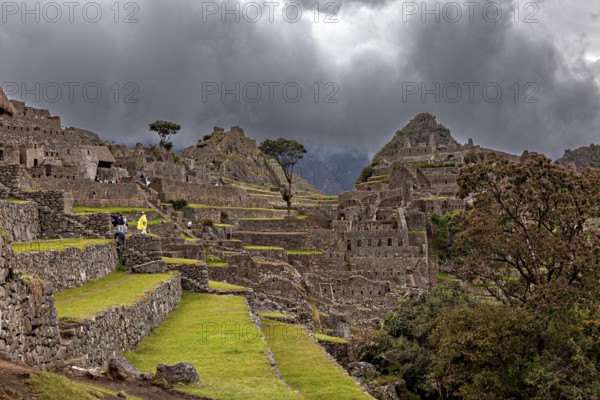 Painting the ruins of Machu Picchu under ominous skies and dramatic mountain scenery, The ruins of