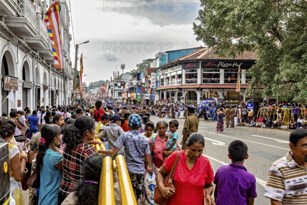 Full of streets with crowds and stalls during a festival, the Perahera Parade in Kandy Sri Lanka