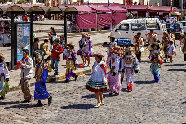 People wearing colorful costumes on a street at a parade, traditional parade of festival groups in
