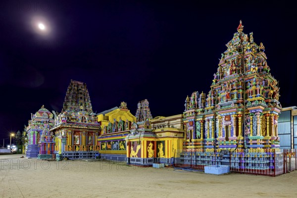 Colourful temples at night in moonlight with artfully designed reliefs, The Sri Pathrakali Amman