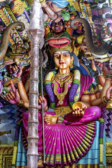 Magnificent sculpture of a goddess in a temple surrounded by detailed decorations, The Sri