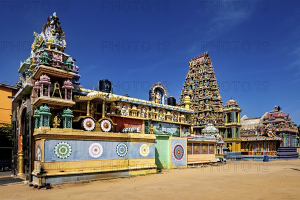 Extensive Hindu temple complex with colorful architecture under clear skies, The Sri Pathrakali