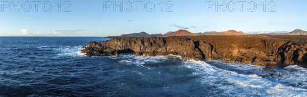 Coast with lava fields, volcanic landscape near Los Hervideros, in the evening light, aerial view,