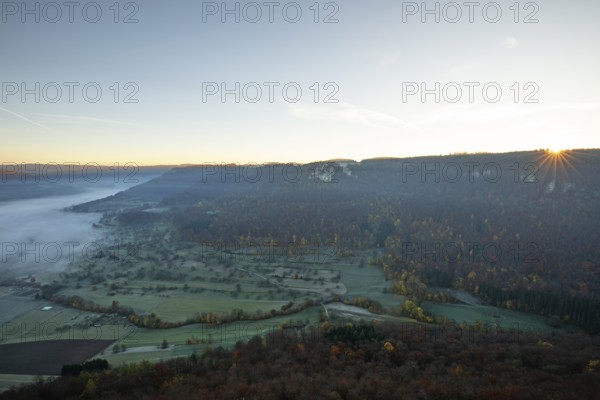 Sunrise with fog in the Neidlinger Valley with a view of the Reussenstein castle ruins. Swabian