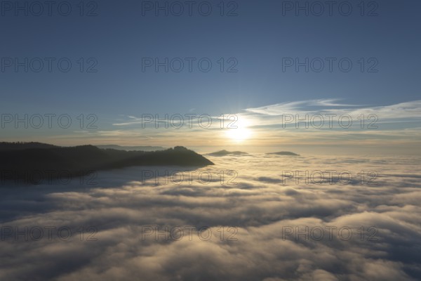 Sunset over the sea of fog from Beurener Fels to Hohenneuffen Castle, Swabian Alb,