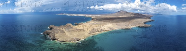 Headland and blue sea, coastal landscape, arid landscape of Los Ajaches Natural Park, aerial view,