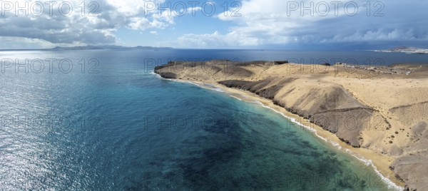 Coast with Playa Caleta del Congrio beach and blue sea, arid landscape of Los Ajaches Natural Park,