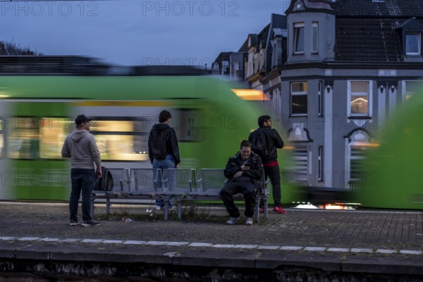 Essen-Steele S-Bahn station, passengers waiting for the train late afternoon, in autumn, Essen,
