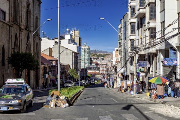 City street in everyday life with cars and passers-by between multi-storey buildings, The city of