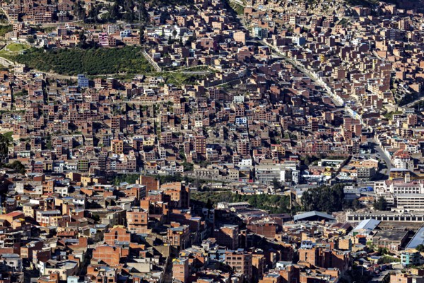 Dense urban development with many brick buildings in hilly surroundings, the city of La Paz in