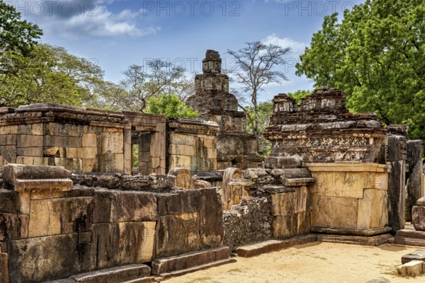 Historic stone ruins with surrounding trees and blue sky as a backdrop, The temples of Polonnaruwa