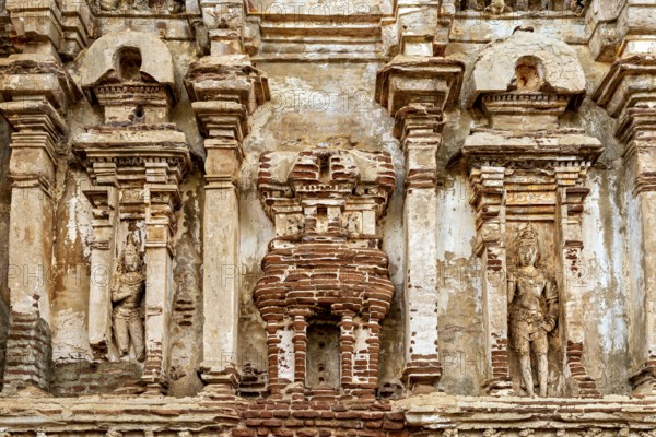Detailed view of an ancient wall with stone reliefs and weathered surface, The temples of