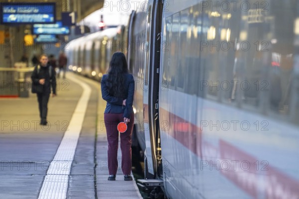 ICE train ready for departure, train staff waiting for the signal to continue, at Essen main