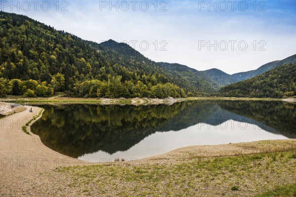 Picturesque mountain lake with water reflections in autumn, Lac de Kruth-Wildenstein, Kruth,