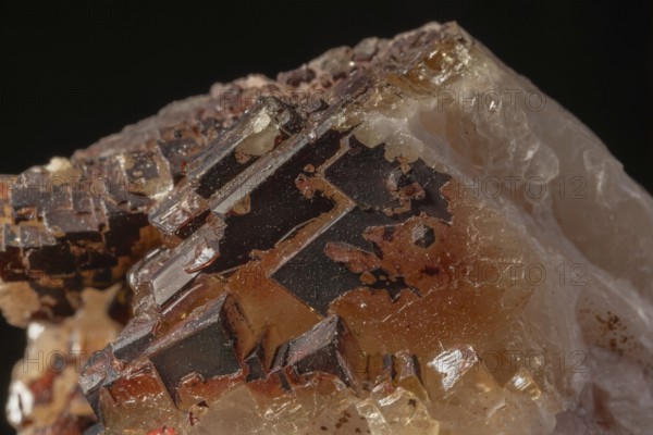 Transparent crystals sit on rocks and reveal their unique shimmer and geological structure. The