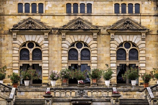 Architectural details with floral arrangements in front of magnificent castle windows, The