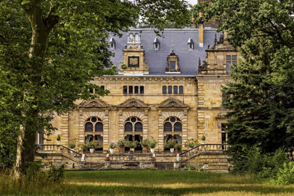 Impressive historic castle surrounded by trees and green lawns, The Hummelshain hunting lodge in