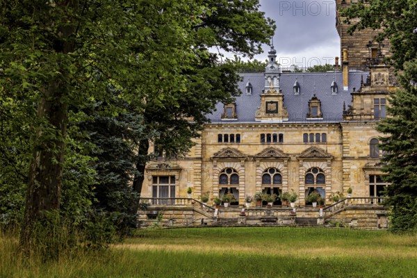 Historic castle surrounded by lush nature and cloudy skies, The Hummelshain hunting lodge in