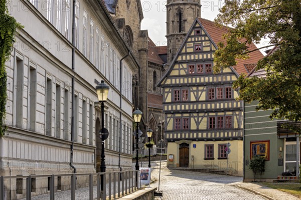 Charming old town with half-timbered houses and cobblestones under shady trees, The old town of