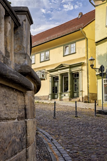 Yellow historic building on a paved street with classic architecture, The old town of Arnstadt in