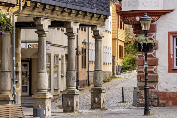 Half-timbered architecture along a quiet cobblestone street with lanterns, The old town of Arnstadt