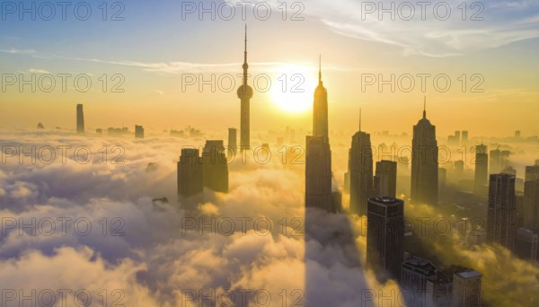 City scape emerging from a dense enveloping fog in sunrise and skyscrapers piercing the haze, big