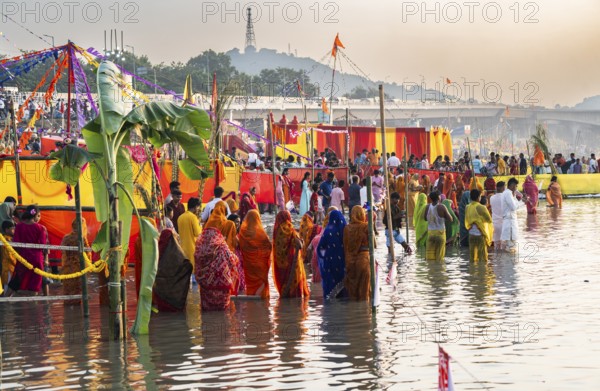 Hindu devotees gather on the banks of the Brahmaputra River to offer prayers to the Sun God on the
