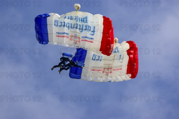 Two parachutists during an aerial acrobatic performance as part of an air show at the Rossfeld in