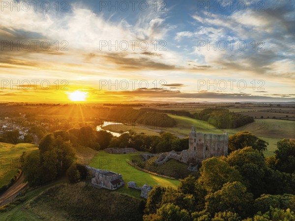 Sunset over Norham Castle and River Tweed from a drone, Norham, Northumberland, England, United