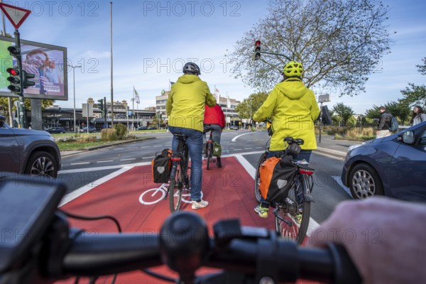 Riding a bike in a bike lane, marked in red to attract the attention of motorists, between 2 lanes,