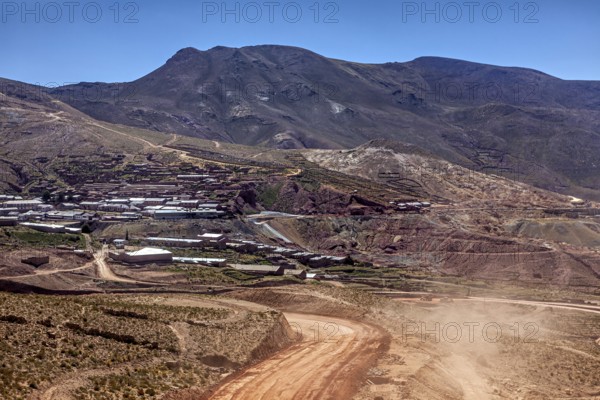 Village on the slope of a mountain in the middle of a dry hilly landscape, The landscape of the